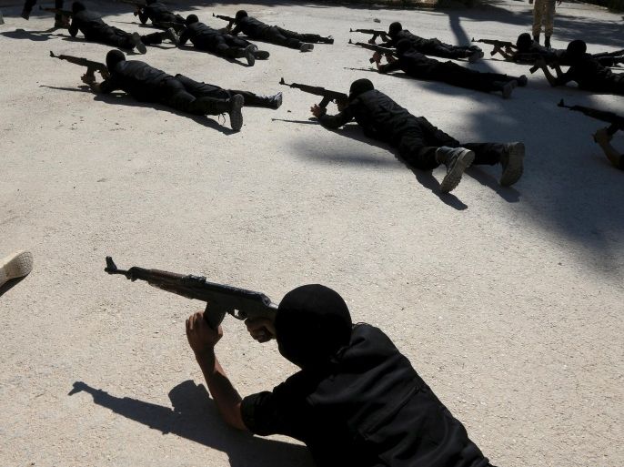 Rebel fighters aim their weapons as they demonstrate their skills during a military display as part of a graduation ceremony at a camp in eastern al-Ghouta, near Damascus, Syria July 11, 2015. The newly graduated rebel fighters, who went through military training, will join the the Free Syrian Army's Al Rahman legion. Picture taken July 11, 2015. REUTERS/Bassam Khabieh
