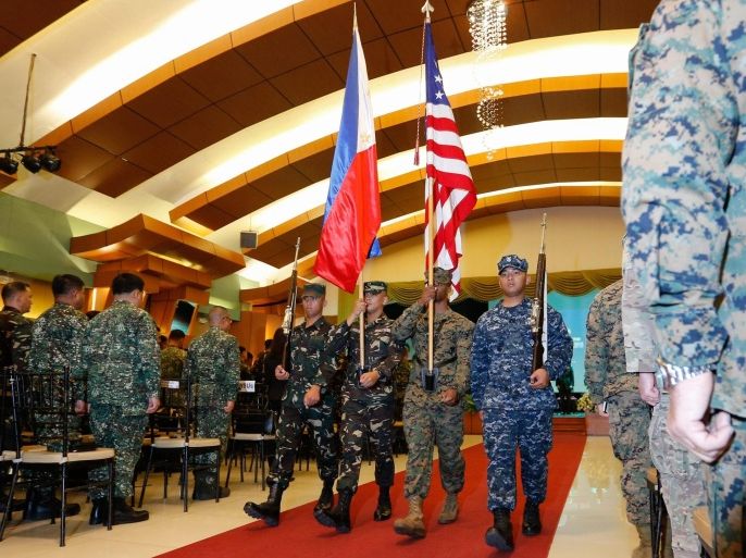 Military troops from the United States and Philippines carrying the US and Philippine flag march during the opening ceremony of Balikatan, a joint Philippines-US Exercise in Quezon City, east of Manila, Philippines, 04 April 2016. The Balikatan (shoulder-to-shoulder) is an annual Philippines-US bilateral military training exercise focused on different missions including environmental protection, maritime law enforcement and humanitarian assistance. The Philippines' newly acquired military assets will be included in the joint exercises, aimed at improving the interoperability of the Philippine and US forces. The bilateral exercise will be held until 15 April.