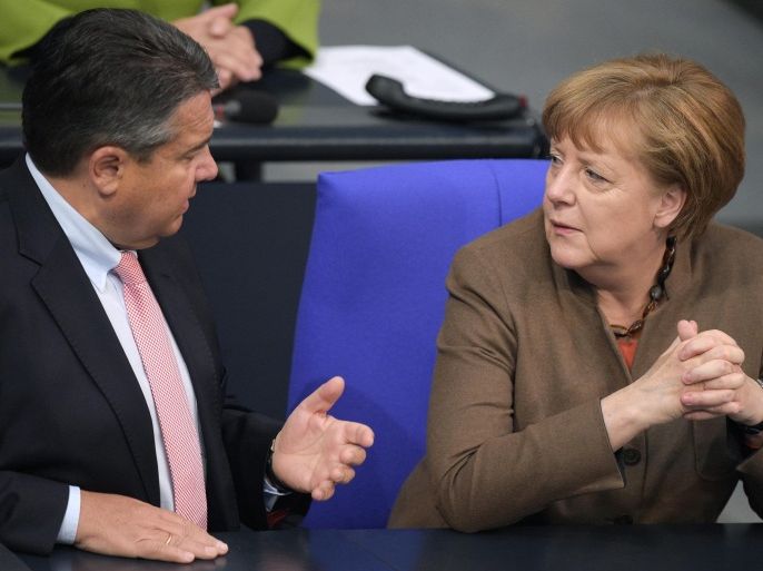 German Chancellor Angela Merkel (R) and German Minister of Economic Affairs and Vice-Chancellor Sigmar Gabriel (L) discuss in the government's bench during a session of the German 'Bundestag' parliament, in Berlin, Germany, 14 April 2016.
