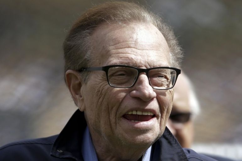 FILE - In this April 1, 2013 file photo. talk show host Larry King attends a season-opening baseball game between the Los Angeles Dodgers and the San Francisco Giants in Los Angeles. Larry King is back on air, beaming his high-octane brand of talk to households around the world. One place you can catch him? Kremlin-backed TV. King will host a political talk show beginning next month. The new program, "Politics with Larry King," will air on the RT America network, a global, English-language channel based in Russia. (AP Photo/Jae C. Hong, File)