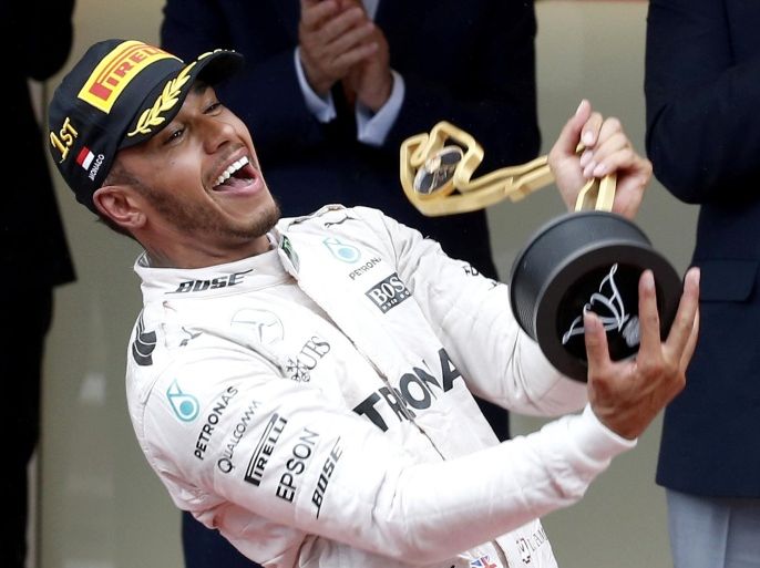 Formula One - Monaco Grand Prix - Monaco - 29/5/16. Mercedes F1 driver Lewis Hamilton celebrates on the podium after winning. REUTERS/Eric Gaillard