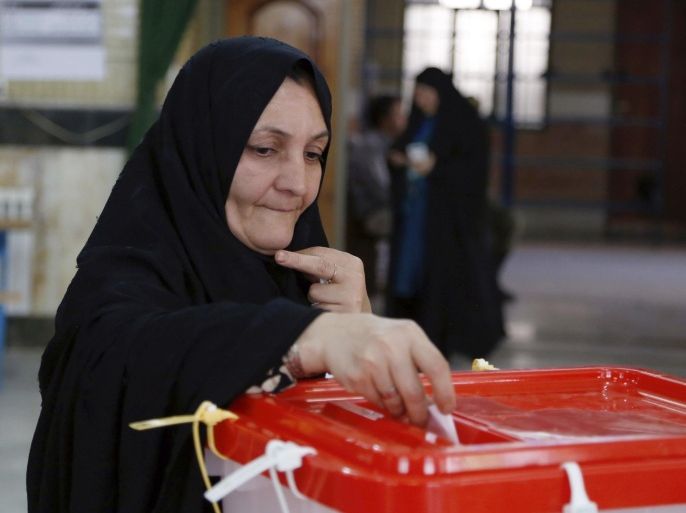 An Iranian woman casts her ballot for the parliamentary runoff elections in a polling station at the city of Qods about 12 miles (20 kilometers) west of the capital Tehran, Iran, Friday, April 29, 2016. Iranians voted Friday in the country's parliamentary runoff elections, a key polling that is expected to decide exactly how much power moderate forces backing President Hassan Rouhani will have in the next legislature. The balloting is for the remaining 68 positions in the 290-seat chamber that were not decided in February's general election, in which Rouhani's allies won an initial majority. (AP Photo)