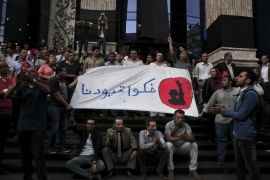 Journalists chant slogans during a protest to mark World Press Freedom Day in front of the Press Syndicate in Cairo, Egypt, Tuesday, May 3, 2016. Memos containing internal instructions from Egypt's Interior Ministry were leaked to the media on Tuesday, outlining strategies on how to deflect public outrage over arrests it made inside the journalists' union, handle the media in general, and deal with the case of an Italian student found tortured to death. Arabic on the banner reads, "remove our shackles." (AP Photo/Nariman El-Mofty)