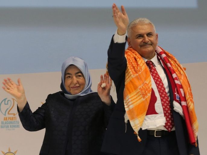 Turkey's Transportation Minister Binali Yildirim (R) and his wife Semiha (L) greet supporters during the Extraordinary Congress of the ruling Justice and Development Party (AKP) to choose the new leader of the party in Ankara, Turkey, 22 May 2016. Binali Yildirim was named on 19 May as the sole candidate to head Turkey's ruling Justice and Development, or AKP, party to succeed Ahmet Davutoglu, who resigned as prime minister.