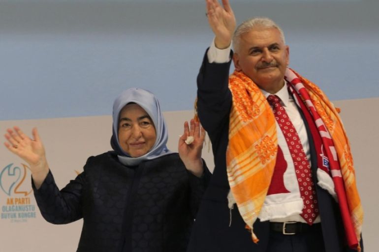 Turkey's Transportation Minister Binali Yildirim (R) and his wife Semiha (L) greet supporters during the Extraordinary Congress of the ruling Justice and Development Party (AKP) to choose the new leader of the party in Ankara, Turkey, 22 May 2016. Binali Yildirim was named on 19 May as the sole candidate to head Turkey's ruling Justice and Development, or AKP, party to succeed Ahmet Davutoglu, who resigned as prime minister.