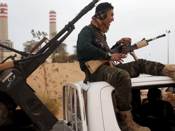 A fighter from Misrata sits on top of a vehicle near Sirte, March 16, 2015. Islamic State fighters became a major force last year in Derna, a jihadi bastion in Libya's east, and quickly spread to the biggest eastern city Benghazi, where they have conducted suicide bombings on streets divided among armed factions. By occupying Sirte over the past four months they have claimed a major city in the centre of the country, astride the coastal highway that links the east and west. Picture taken March 16, 2015. REUTERS/Goran Tomasevic/File