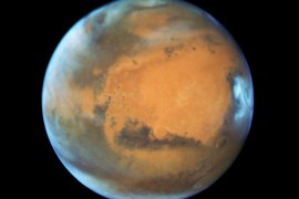A handout photograph made avaiable on 20 May 2016 showing the plant Mars covered in clouds viewed by the Hubble Space Telescope on 12 May 2016. The image taken to show off the effects the seasons have on the red planet. This observation was made just a few days before Mars opposition on 22 May 2016, when the sun and Mars will be on exact opposite sides of Earth, and when Mars will be at a distance of 47.4 million miles from Earth. On 30 May 2016 Mars will be the closest it has been to Earth in 11 years, at a distance of 46.8 million miles. Mars is especially photogenic during opposition because it can be seen fully illuminated by the sun as viewed from Earth. EPA/NASA / HUBBLE / HANDOUT