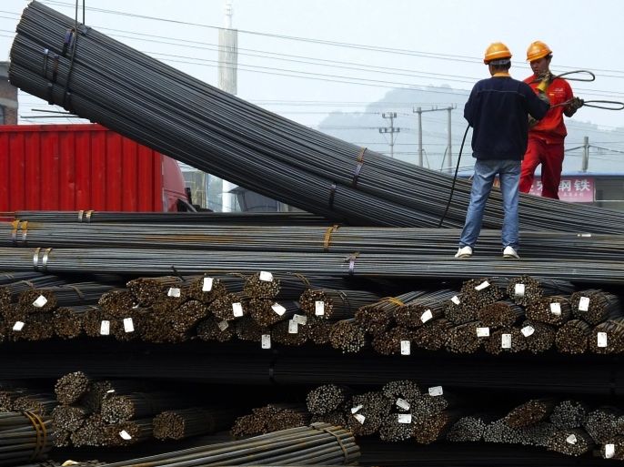 In this April 29, 2016 photo, workers load steel bars at a steel market in Yichang in central China's Hubei province. China's Cabinet has approved measures to boost exports in a move that might worsen tensions with trading partners that say Beijing is flooding their markets with unfairly low-priced steel and other goods. The announcement late Monday, May 9 comes as Beijing struggles to reduce a glut of goods in an array of industries and reverse an export decline that threatens to cause politically dangerous job losses. (Chinatopix via AP) CHINA OUT