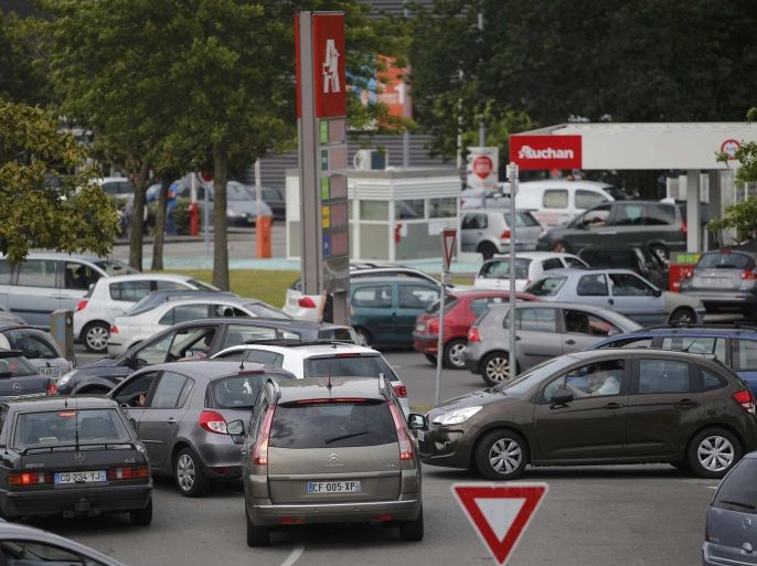 Cars wait to get gas at a petrol station at a supermarket in Saint-Sebastien-sur-Loire near Nantes, France, May 21, 2016 as Total has halted output at some units of three of its refineries in France due to protests over proposed labour law reform that have prompted a blockade of oil depots and petrol stations. REUTERS/Stephane Mahe ATTENTION EDITORS FRENCH LAW REQUIRES THAT VEHICLE REGISTRATION PLATES ARE MASKED IN PUBLICATIONS WITHIN FRANCE