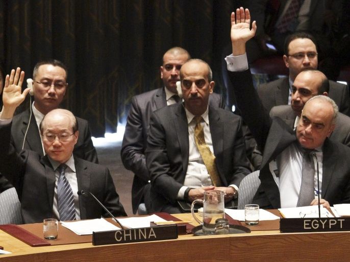 Chinese ambassador to the United Nations Liu Jieyi, left, and Egypt ambassador to the U.N. Abdellatif Aboulatta, right, vote on a resolution during a Security Council meeting at U.N. headquarters, Wednesday, March 2, 2016. The U.N. Security Council has unanimously approved the toughest sanctions on North Korea in two decades. (AP Photo/Bebeto Matthews)