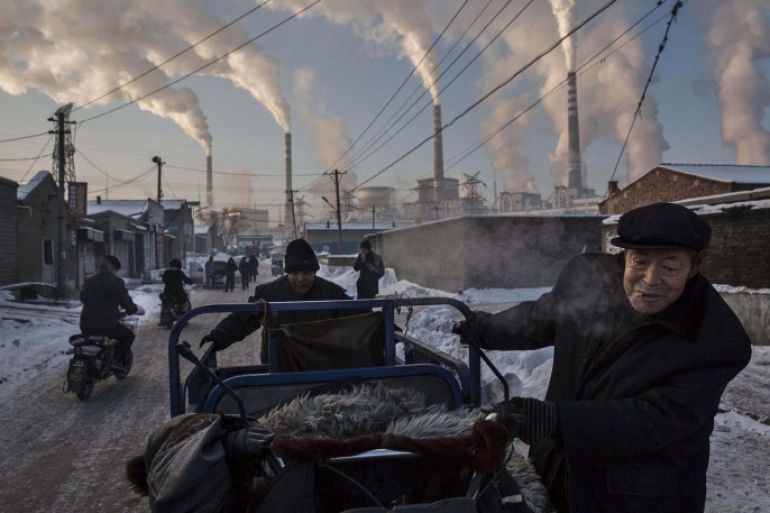 Daily Life, 1st prize singles, World Press Photo Awards (Kevin Frayer - China's Coal Addiction)Chinese men pull a tricycle in a neighborhood next to a coal-fired power plant in Shanxi, China, November 26, 2015. A history of heavy dependence on burning coal for energy has made China the source of nearly a third of the world's total carbon dioxide (CO2) emissions, the toxic pollutants widely cited by scientists and environmentalists as the primary cause of global warmin