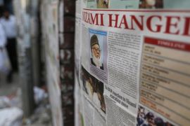 Bangladeshi men walk past newspapers, pasted on a wall which has news of the execution of Jamaat-e-Islami party chief Motiur Motiur Rahman Nizami, in Dhaka, Bangladesh, Wednesday, May 11, 2016. The head of Bangladesh's largest Islamist party was executed early Wednesday for his role in acts of genocide and war crimes during the country's independence war against Pakistan in 1971, a senior government official said. (AP Photo)