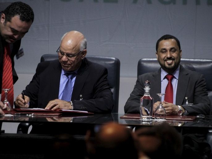 Libya's Tripoli-based General National Congress (GNC) representative Salih el-Mahzum (R) and Libya's Tobruk-based government's representative Muhammed Shuayb (L) sign the "Libyan Political Agreement" in Suheirat, Morocco December 17, 2015. REUTERS/Stringer EDITORIAL USE ONLY. NO RESALES. NO ARCHIVE TPX IMAGES OF THE DAY