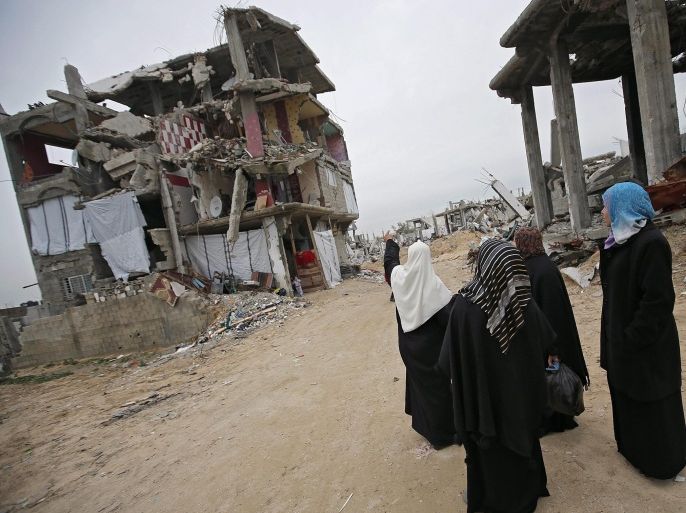 Palestinian women stand next to destroyed buildings in Al Shejaiya neighbourhood in the east of Gaza City, 23 February 2015. On 15 February 2014, international mediator and former British prime minister Tony Blair said if conditions in the impoverished Gaza Strip remained the same, then it would be a 'crime against humanity.' Blair, the envoy of the so-called Quartet of Middle East peace mediators, had visited the coastal enclave for several hours, six months after a deadly and destructive Israeli offensive in the strip, launched in response to years of rocket attacks. EPA/MOHAMMED SABER