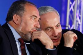 Israel's Prime Minister Benjamin Netanyahu (R) converses with former Foreign Minister Avigdor Lieberman during a Likud-Yisrael Beitenu campaign rally in the southern Israeli city of Ashdod January 16, 2013. REUTERS/Amir Cohen/File Photo