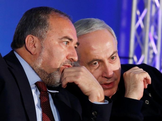Israel's Prime Minister Benjamin Netanyahu (R) converses with former Foreign Minister Avigdor Lieberman during a Likud-Yisrael Beitenu campaign rally in the southern Israeli city of Ashdod January 16, 2013. REUTERS/Amir Cohen/File Photo