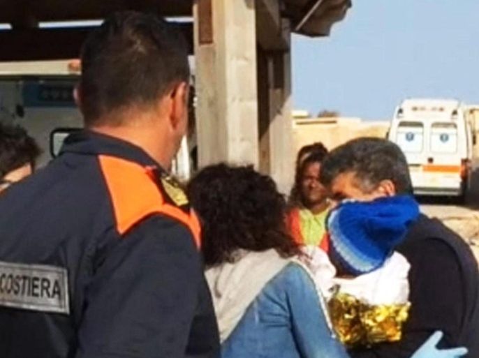 A handout still image grabbed from a video released by Italian Coast Guard press office on 26 May 2016 shows a 9-month-old refugee baby arriving in Lampedusa without parents, in Lampedusa, Sicily Island, Italy, on 25 May 2016. The baby girl named 'Favour' from Mali travelled in a boat with her pregnant mother and father that did not survive the boat ride. Favour, that was cared for by island's doctor Pietro Bartolo, is now in police care reports state. The boat, carr