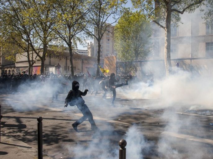 Masked protesters clash with riot police during a demonstration against the French Government's labor law reform bill in Paris, France, 01 May 2016. This march takes place in an atmosphere of massive protest again French labor reform project which will be discussed at the French Parliament on 03 May.
