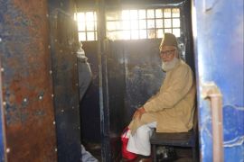 Motiur Rahman Nizami, a leader of Bangladesh Jamaat-E-Islami sits inside a prison vehicle as he leaves a court after a verdict of an arms smuggling case in Chittagong January 30, 2014. A Bangladeshi court sentenced to death on Thursday 14 people including Nizami, a former security agency chief and a former deputy government minister for involvement in the country's biggest ever arms smuggling case. Police seized 10 truck-loads of weapons in a raid on a state-owned jetty in the southeastern port city of Chittagong in 2004. REUTERS/Stringer (BANGLADESH - Tags: POLITICS CRIME LAW)