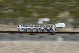 A sled speeds down a track during a test of a Hyperloop One propulsion system, Wednesday, May 11, 2016, in North Las Vegas, Nev. The startup company opened its test site outside of Las Vegas for the first public demonstration of technology for a super-speed, tube based transportation system. (AP Photo/John Locher)