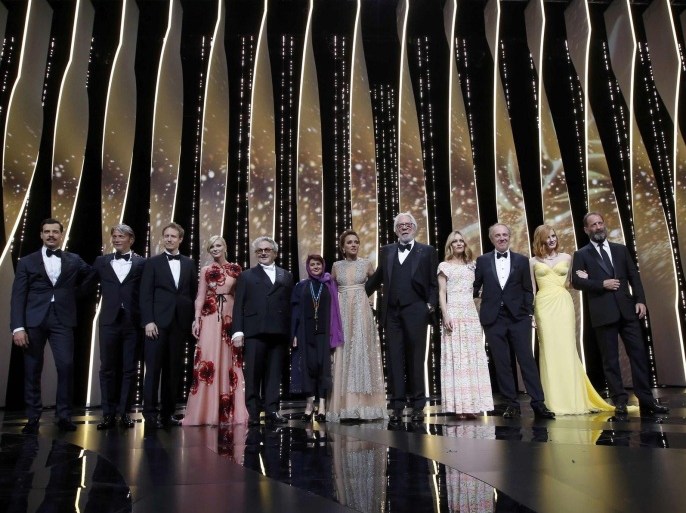 Director George Miller, Jury President of the 69th Cannes Film Festival, and Jury members director Arnaud Desplechin, actress Kirsten Dunst, actress Valeria Golino, actor Mads Mikkelsen, director Laszlo Nemes, actress and singer Vanessa Paradis, film producer Katayoon Shahabi and actor Donald Sutherland pose with actor Vincent Lindon and actress Jessica Chastain and Master of Ceremony actor Laurent Lafitte on stage for the opening ceremony and the screening of the film "Cafe Society" out of competition during the 69th Cannes Film Festival in Cannes, France, May 11, 2016. REUTERS/Jean-Paul Pelissier