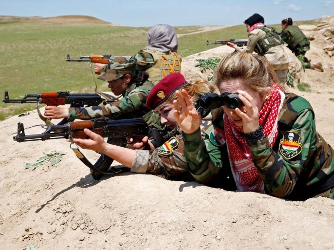 Iraqi Kurdish female fighter Haseba Nauzad (2nd R), 24, and Yazidi female fighter Asema Dahir (3rd R), 21, aim their weapon during a deployment near the frontline of the fight against Islamic State militants in Nawaran near Mosul, Iraq, April 20, 2016. When Islamic State swept into the northern Iraqi town of Sinjar in 2014, a few young Yazidi women took up arms against the militants attacking women and girls from their community. The killing and enslaving of thousands f