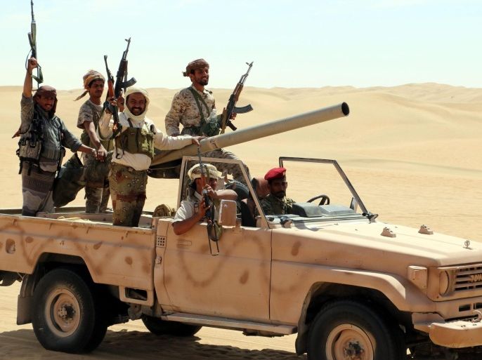 A photograph made available on 23 February 2016 shows pro-Yemeni government fighters riding a truck during a gathering in a desert area reportedly ahead of an offensive against al-Qaeda-held southern towns, in the eastern province of Shabwa, Yemen, 22 February 2016. According to reports, Al-Qaeda in the Arabian Peninsula (AQAP) has seized control of a coastal town in Yemen's southern Abyan province two days ago, the latest in a series of recent advances in the region t