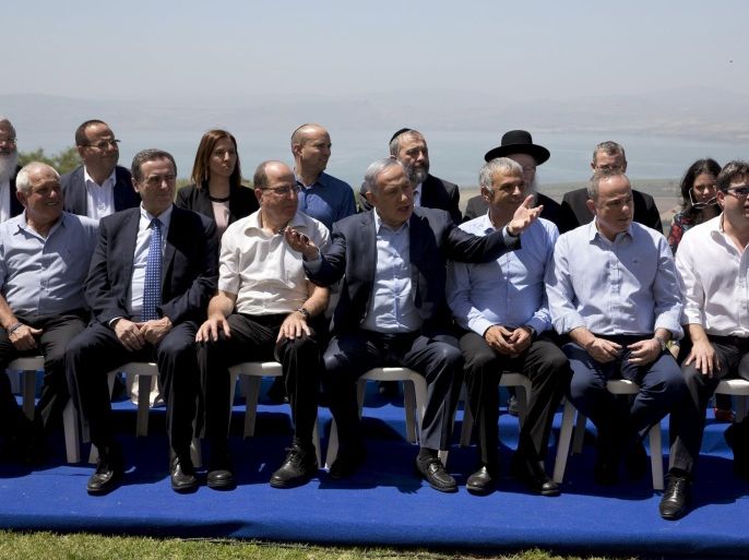 Israeli Prime Minister Benjamin Netanyahu (C front) poses with ministers prior to the weekly cabinet meeting in the Israeli occupied Golan Heights near the ceasefire line between Israel and Syria, April 17, 2016. REUTERS/Sebastian Scheiner/Pool