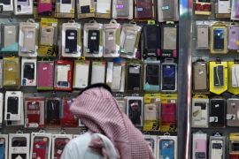 A Saudi vendor looks at cases at a mobile shop in Riyadh, Saudi Arabia March 21, 2016. In early March, the Ministry of Labour announced that within six months foreigners would be banned from selling and maintaining mobile phones and accessories for them, in an effort to keep open more jobs for Saudi citizens. Picture taken March 21, 2016. REUTERS/Faisal Al Nasser