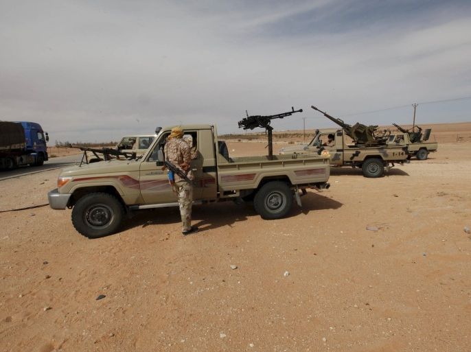 Libyan military vehicles are pictured at a checkpoint in Wadi Bey, west of the Islamic State-held city of Sirte, February 23, 2016. REUTERS/Ismail Zitouny