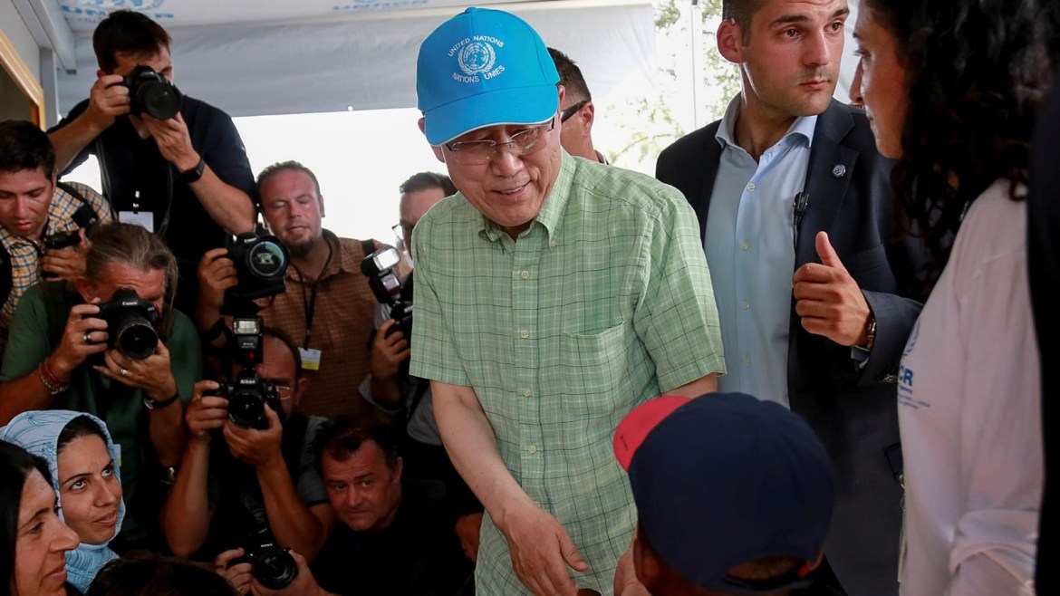 U.N. Secretary-General Ban Ki-moon (C) greets a child during his visit at the municipality-run refugee camp of Kara Tepe on the island of Lesbos, Greece, June 18, 2016. Intimenews/Manolis Lagoutaris/via REUTERS ATTENTION EDITORS - THIS IMAGE WAS PROVIDED BY A THIRD PARTY. EDITORIAL USE ONLY. GREECE OUT