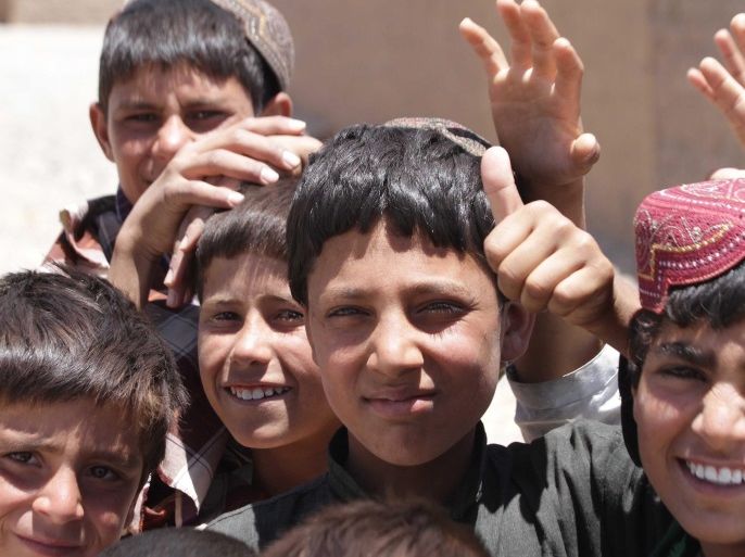 Afghan internally displaced children pose for a photo during the visit of United Nations High Commissioner for Refugees (UNHCR) Italian Filippo Grandi (not pictured) at Maslakh, a camp for Internally Displaced Persons, on the outskirts of Herat city, Afghanistan, 19 June 2016. Fillipo Grandi, on 19 June, visited the camp to monitor the condition of the displaced people, refugees, meeting local officials, including Asef Rahimi the governor to find solution of the displac