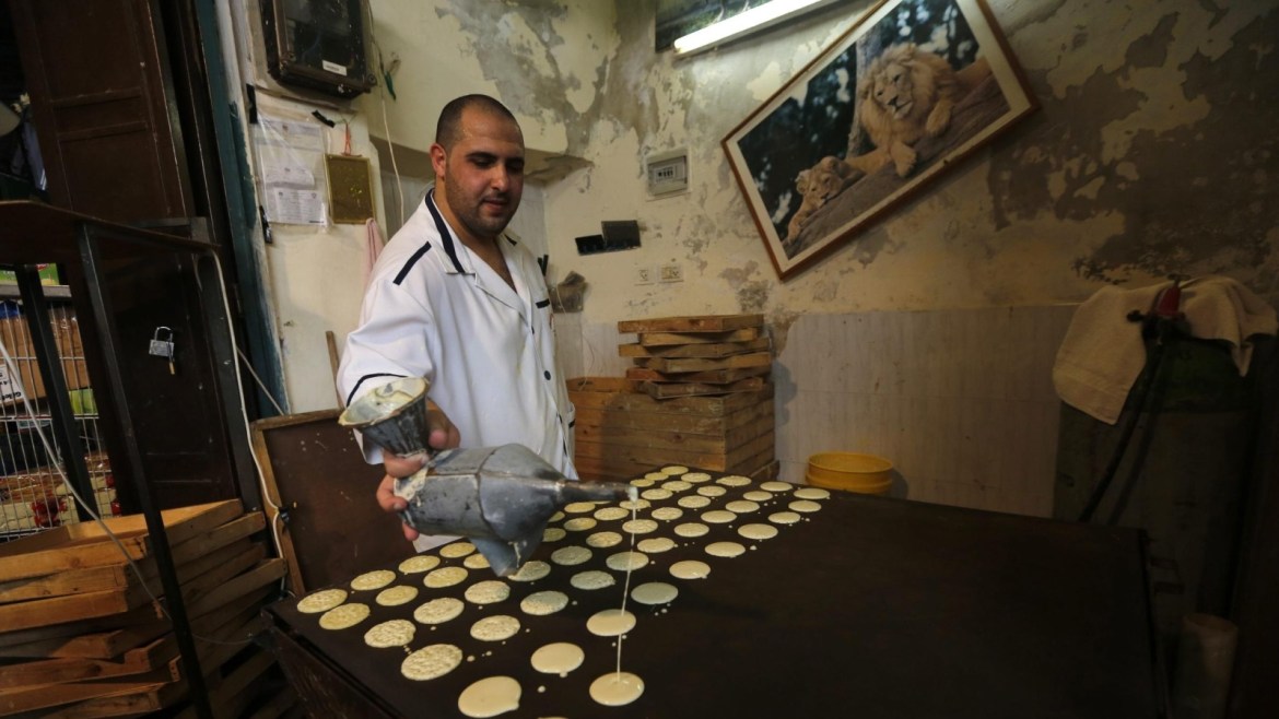 A Palestinian candy vendor makes a traditional special sweet (Qatayef), for the month of Ramadan, at his shop in the West Bank city of Nablus, 07 June 2016. Muslims around the world celebrate the holy month of Ramadan by praying during the night time and abstaining from eating and drinking during the period between sunrise and sunset. Ramadan is the ninth month in the Islamic calendar and it is believed that the Koran's first verse was revealed during its last 10 nights.