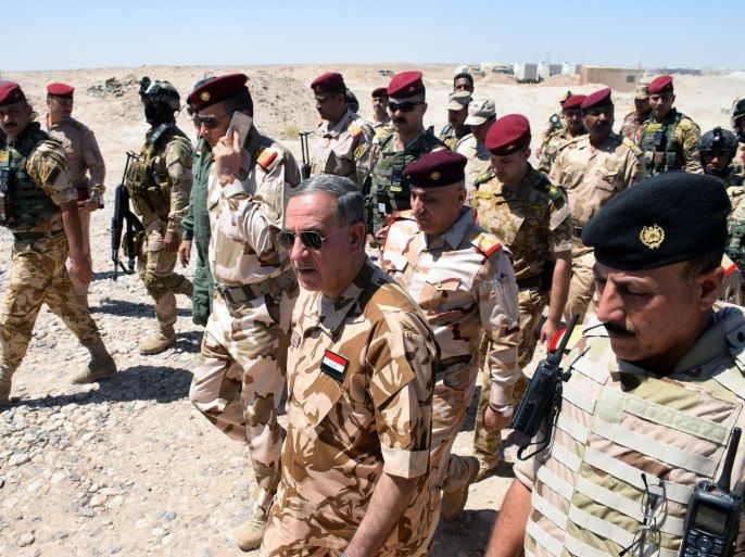 Iraqi Defence Minister Khaled al-Obaidi (C) walks with Iraqi army officers during his visit to the military forces in western Fallujah city, west of Iraq, 11 June 2016. According to Iraqi officials, Iraqi troops backed by airstrikes carried out by the international anti-IS coalition to liberate Nassaf area west of Fallujah city, from the hands of the Islamic State (IS).