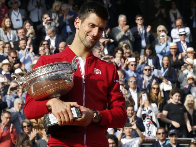 Tennis - French Open Men's Singles Final match - Roland Garros - Novak Djokovic of Serbia v Andy Murray of Britain - Paris, France - 05/06/16. Djokovic celebrates with the trophy after winning. REUTERS/Jacky Naegelen