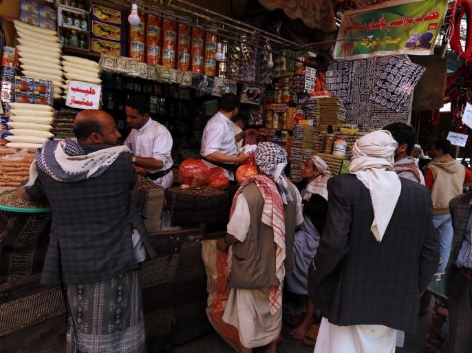 People shop at a market in the old city of Sana'a, Yemen, 17 May 2016. The 14-month conflict between Houthi rebels and Saudi-backed government focres has driven up the prices of basic foodstuffs.