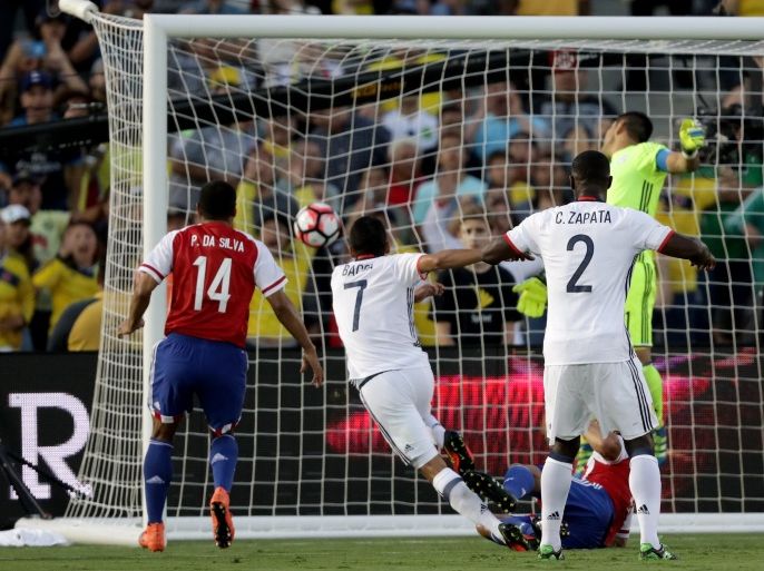 Pasadena, California, UNITED STATES : PASADENA, CA - JUNE 07: Cristian Zapata #2 of Colombia watches as Carlos Bacca #7 of Colombia scores a goal during the first half of a 2016 Copa America Centenario Group A match between Columbia and Paraguay at Rose Bowl on June 7, 2016 in Pasadena, California. Paulo da Silva #14 of Paraguay looks on. Sean M. Haffey/Getty Images/AFP