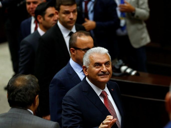 Turkey's Prime Minister Binali Yildirim greets members of parliament from his ruling AK Party (AKP) during a meeting at the Turkish parliament in Ankara, Turkey, June 14, 2016. REUTERS/Umit Bektas