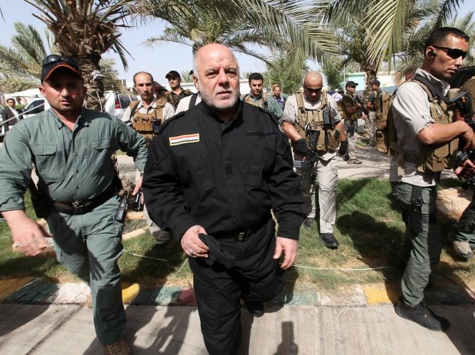 Iraq's Prime Minister Haider al-Abadi (front 2nd L) walks during his visit to an Iraqi army base in Camp Tariq near Falluja, Iraq, June 1, 2016. To match Analysis MIDEAST-CRISIS/IRAQ-ABADI REUTERS/Alaa Al-Marjani/File Photo TPX IMAGES OF THE DAY