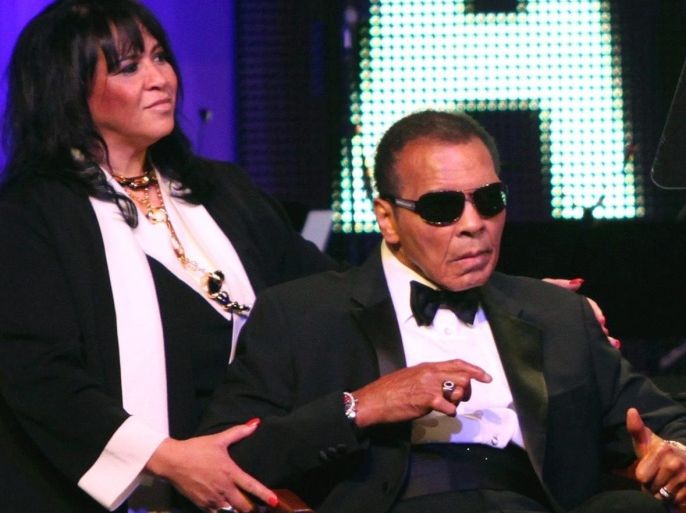 (FILE) US former boxer Muhammad Ali (R) attends the Muhammad Ali's Celebrity Fight Night XVIII in Phoenix, Arizona, USA, 24 March 2012. An unidentified helper stands at left. Ali has been admitted to hospital for respiratory problems, media reported on 03 June 2016.