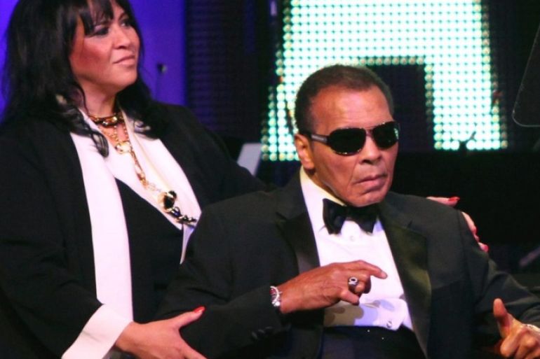 (FILE) US former boxer Muhammad Ali (R) attends the Muhammad Ali's Celebrity Fight Night XVIII in Phoenix, Arizona, USA, 24 March 2012. An unidentified helper stands at left. Ali has been admitted to hospital for respiratory problems, media reported on 03 June 2016.