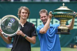 German tennis players Alexander Zverev (l-r) and winner Florian Mayer present their trophies at the award ceremony after the final at the ATP tournament in Halle, Germany, 19 June 2016.