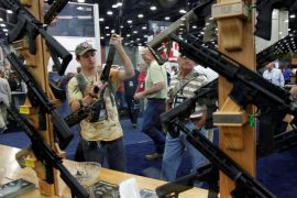 Gun enthusiasts look over Rock River Arms' guns at the National Rifle Association's annual meetings and exhibits show in Louisville, Kentucky, May 21, 2016. REUTERS/John Sommers II