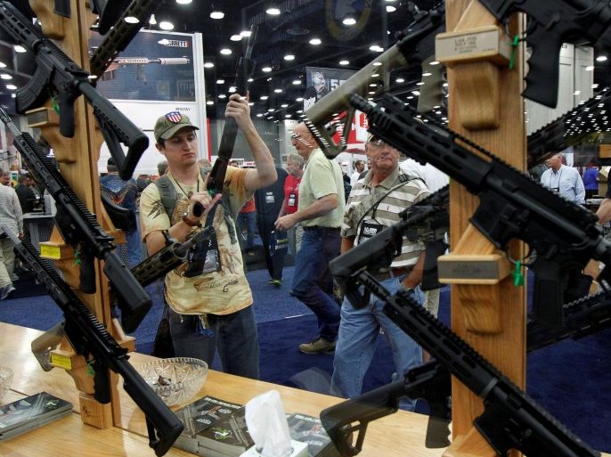 Gun enthusiasts look over Rock River Arms' guns at the National Rifle Association's annual meetings and exhibits show in Louisville, Kentucky, May 21, 2016. REUTERS/John Sommers II