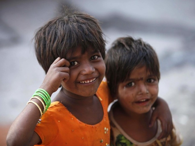 Two Indian girls react to the camera as they play on a street outside their roadside shanty, on International Day of the Girl Child in Hyderabad, India, Thursday, Oct. 11, 2012. In India, where there are 914 girls under age 6 for every 1,000 boys, discrimination happens through abortions of female fetuses and sheer neglect of young girls, despite years of high-profile campaigns to address the issue. Every few years, federal and state governments announce new incentives, from free meals to free education, to encourage people to take care of their girls.