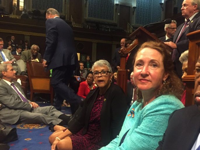 A photo shot and tweeted from the floor of the House by U.S. House Rep. David Cicilline shows Democratic members of the U.S. House of Representatives, including Rep. John Lewis (R) staging a sit-in on the House floor "to demand action on common sense gun legislation" on Capitol Hill in Washington, United States, June 22, 2016. REUTERS/ U.S. Rep. David Cicilline/Handout