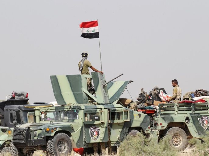 Iraqi security forces sit in military vehicles in the Nuaimiya suburb of Fallujah, Iraq, June 1, 2016. REUTERS/Alaa Al-Marjani