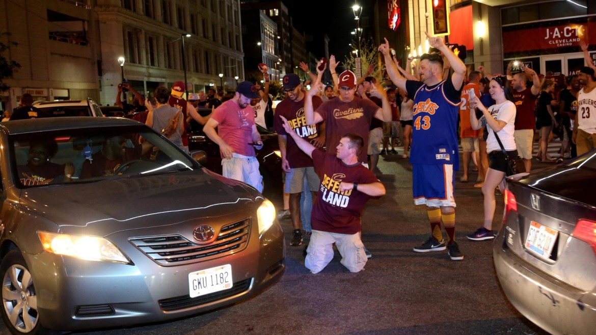 Cleveland Cavaliers fans celebrate in the streets outside of Quicken Loans Arena in Cleveland, Ohio after the Cavaliers defeated the Golden State Warriors in the NBA Championship Game played in Oakland, California June 19, 2016.  REUTERS/Aaron Josefczyk