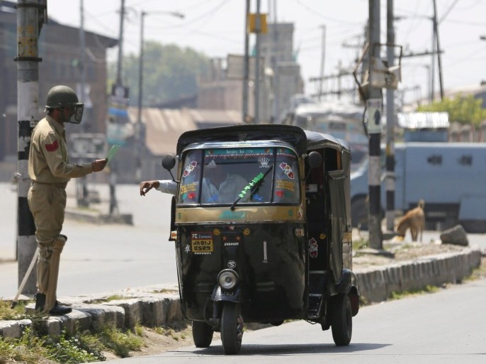 An Indian policeman stops a auto rickshaw during the implementation of restrictions in Srinagar, the summer capital of Indian Kashmir, India, 21 May 2016. Authorities imposed restrictions in the old quarters of Srinagar to supress a separatist rally commemorating the anniverssary of the deaths of the late religious leader Mirwaiz Mohammad Farooq and separatist leader Abdul Gani Lone. Both leaders were killed on the same day, 21 May 1990 and 2002 respectively. Shops, edu