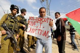Israeli Border Police and army soldiers block Palestinian protesters from advancing near the southern West Bank village of Jab'a, 14 March 2015. The protesters carried posters referring to the BDS (Boycott, Divestment and Sanctions) movement which aims to put pressure on Israel to end its engagement in the Palestinian territories.